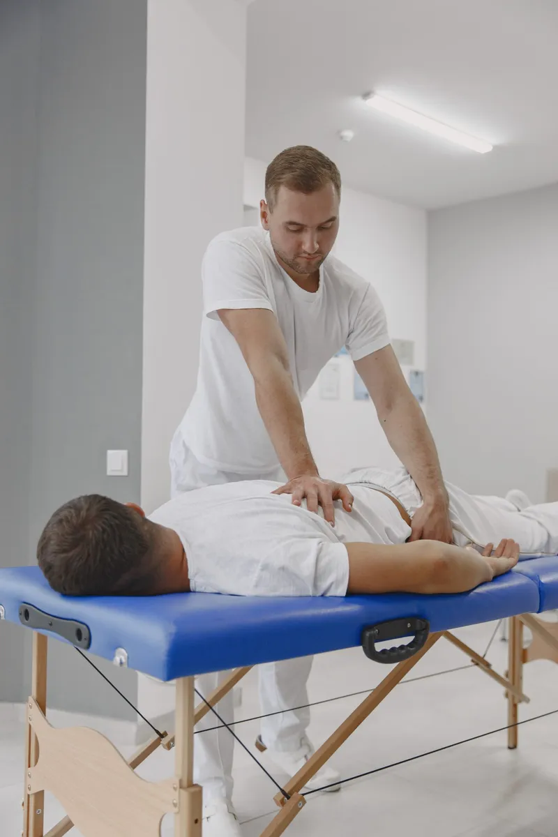 Chiropractor treating a patient on a table